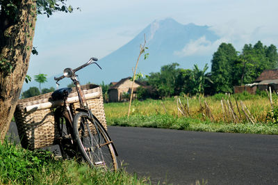 Bicycle on road amidst field