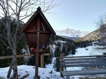 Built structure on snow covered landscape against sky