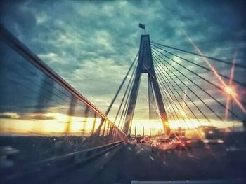 Bridge over river at sunset