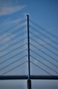 Low angle view of suspension bridge against sky