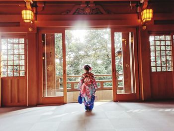 Rear view of girl wearing traditional clothing at temple