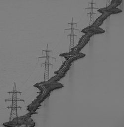 Low angle view of electricity pylon against sky