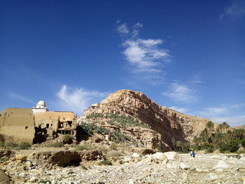 Panoramic view of rocks and mountains against blue sky