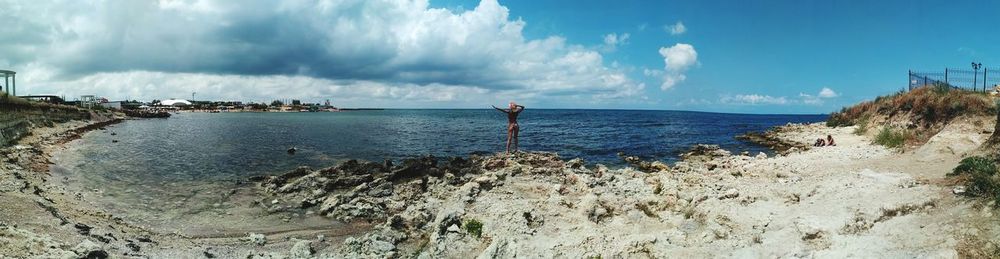 Panoramic shot of sea shore against sky