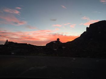 Silhouette of building against sky during sunset