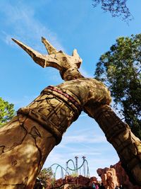 Low angle view of horse statue against sky