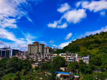 Buildings in city against cloudy sky