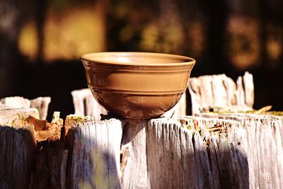 Close-up of coffee cup on wood