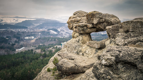 Rock formation on landscape against sky