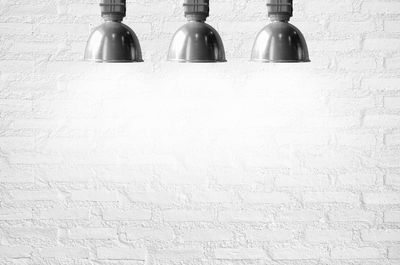 Low angle view of empty bottles on wall