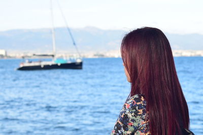 Rear view of woman looking at sea against sky