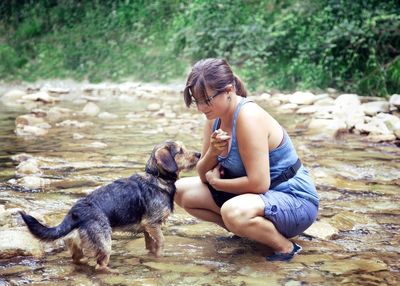 Full length of woman with dog