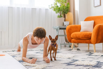 Concept healthy lifestyle. yoga and fitness. cute woman with small dog