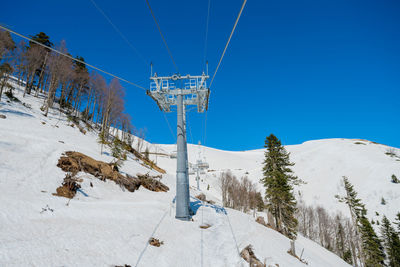 Low angle view of ski lift against clear sky