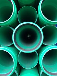 Full frame shot of stacked green pipes