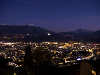 High angle view of illuminated buildings in city at night