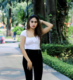 Portrait of beautiful young woman standing outdoors