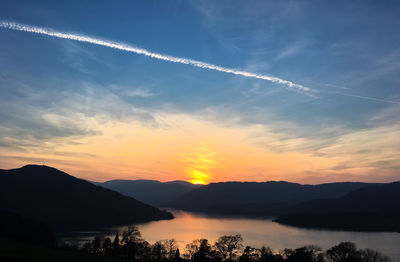 Scenic view of silhouette mountains against sky at sunset