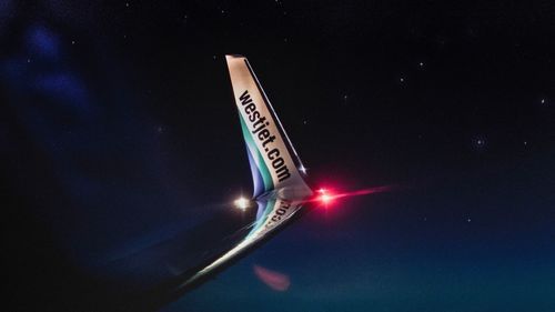 Information sign against sky at night