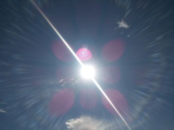 Low angle view of sun shining in sky