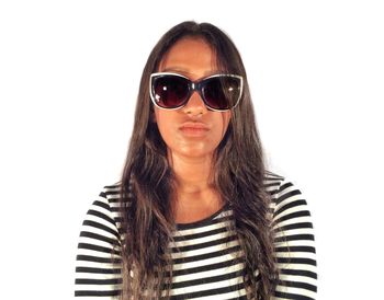Portrait of woman wearing sunglasses against white background