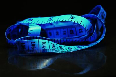 Close-up of information sign on table against black background