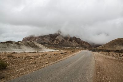 Road leading towards mountains against sky anarak desert roadtrip