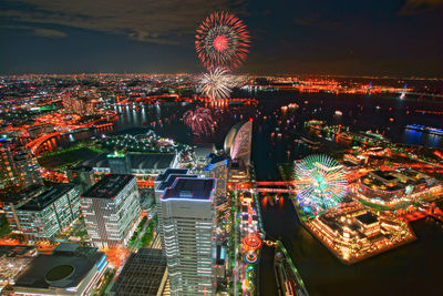 High angle view of illuminated buildings in city at night