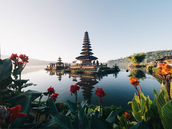 Scenic view of lake by building against clear sky