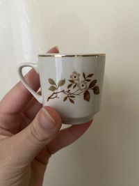 Close-up of hand holding tea cup