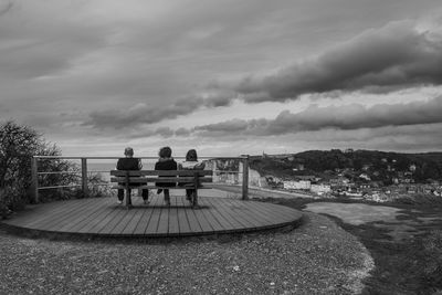 Silhouette of woman against cloudy sky