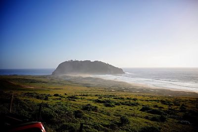 Scenic view of sea against blue sky