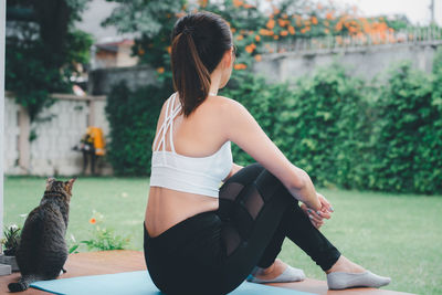 Rear view of woman sitting outdoors