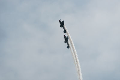 Low angle view of airplane flying against sky