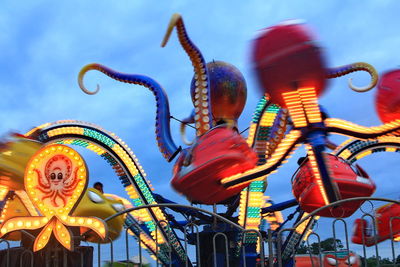 Low angle view of carousel against sky