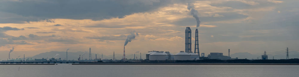 Commercial dock by sea against sky