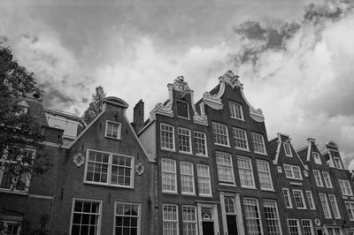 Low angle view of building against cloudy sky