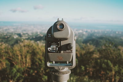 Close-up of vintage telescope against sky