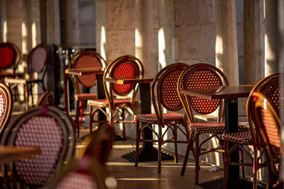 Empty chairs and tables arranged in restaurant