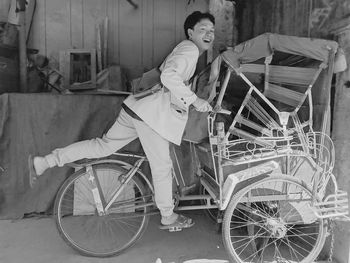 Portrait of adult sitting on rickshaw 