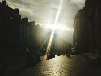 Street amidst buildings against sky in city