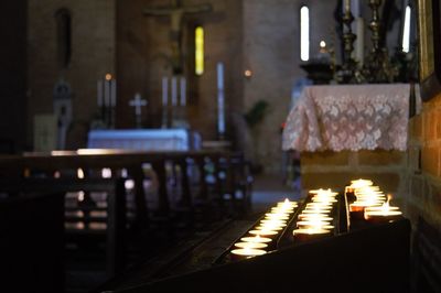 Close-up of illuminated table inside a church