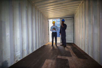 People standing in corridor of building