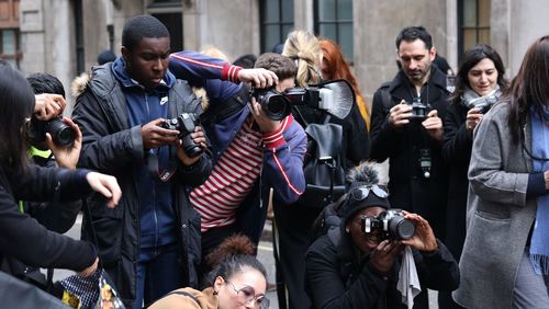 Group of people photographing at music concert