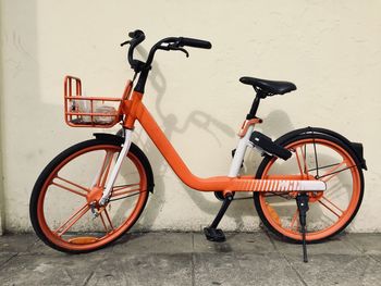 Bicycle parked against wall