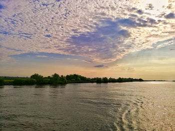 Scenic view of lake against sky during sunset