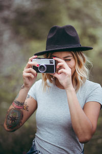 Young woman photographing with mobile phone