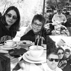 Portrait of happy friends sitting on table