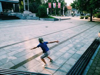 Rear view of boy on footpath