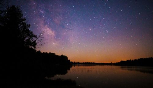 Scenic view of lake against star field at night